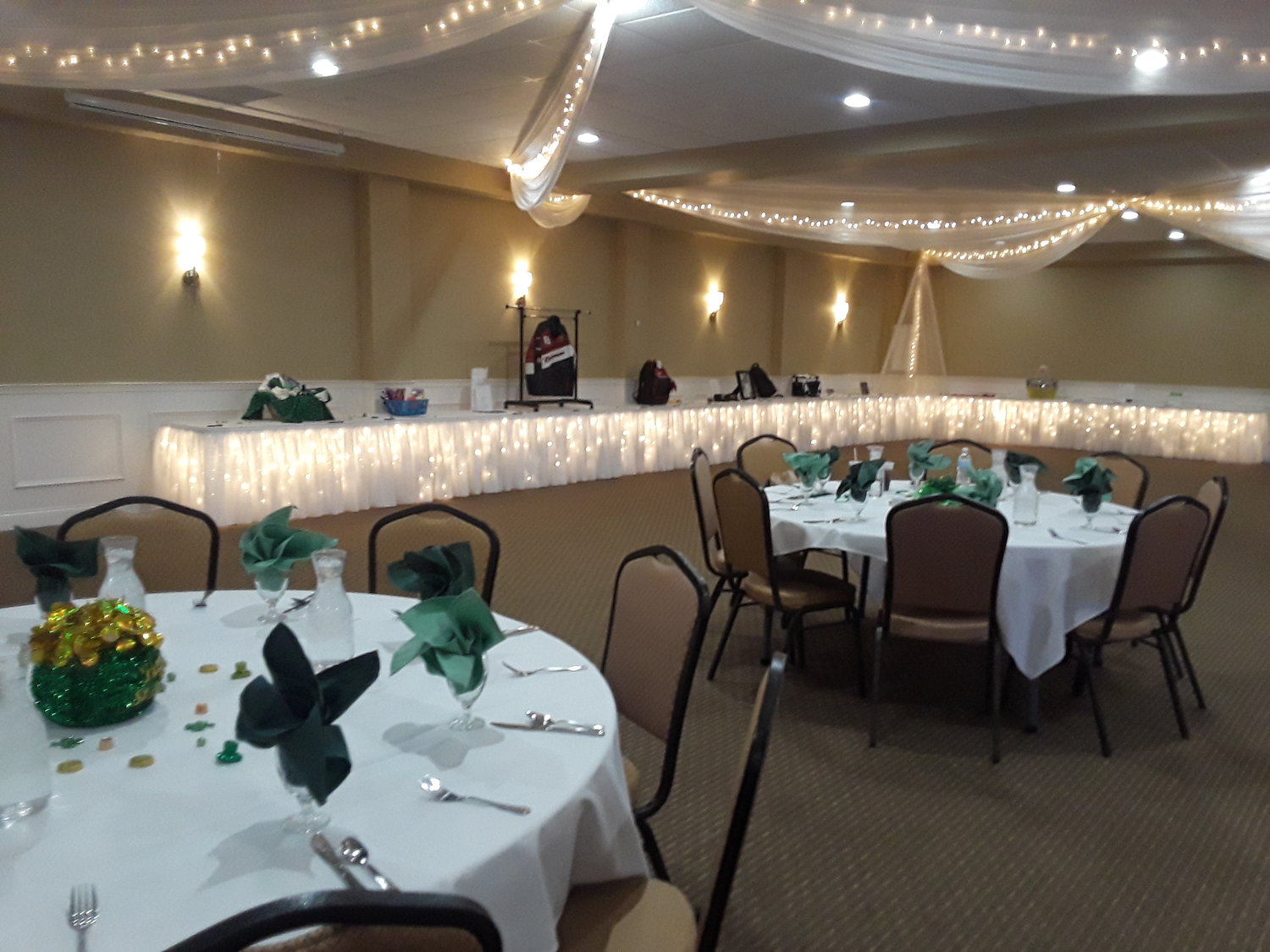 Event with white covered tables and green centerpieces at Banquets of Minnesota