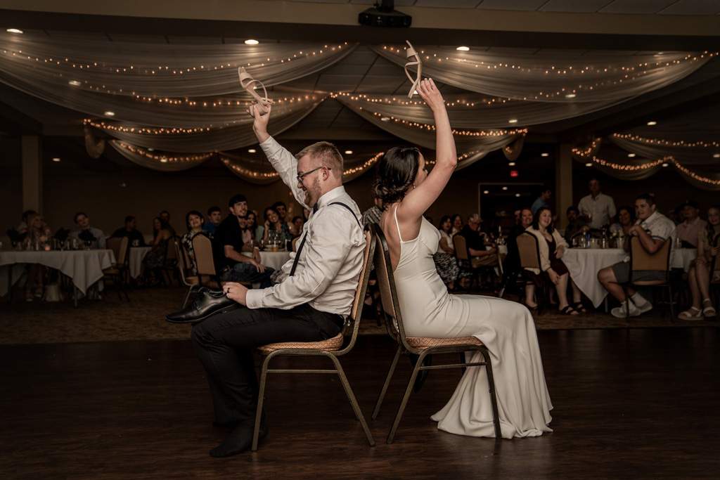 Bride and groom playing the shoe game at their wedding reception