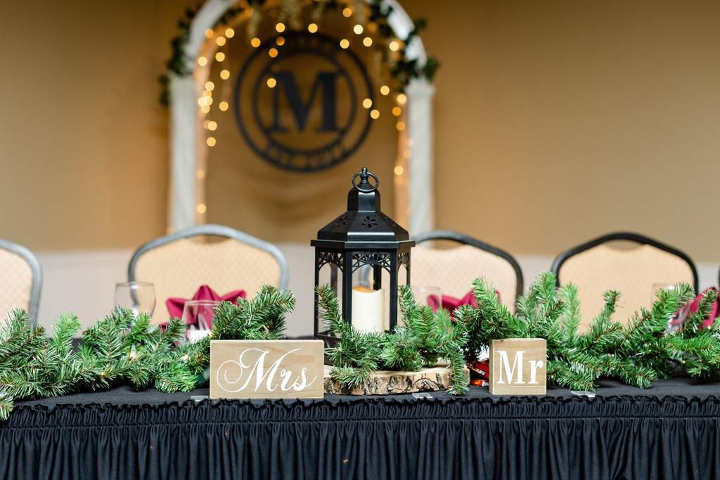 Wedding reception head table with mr and mrs signs
