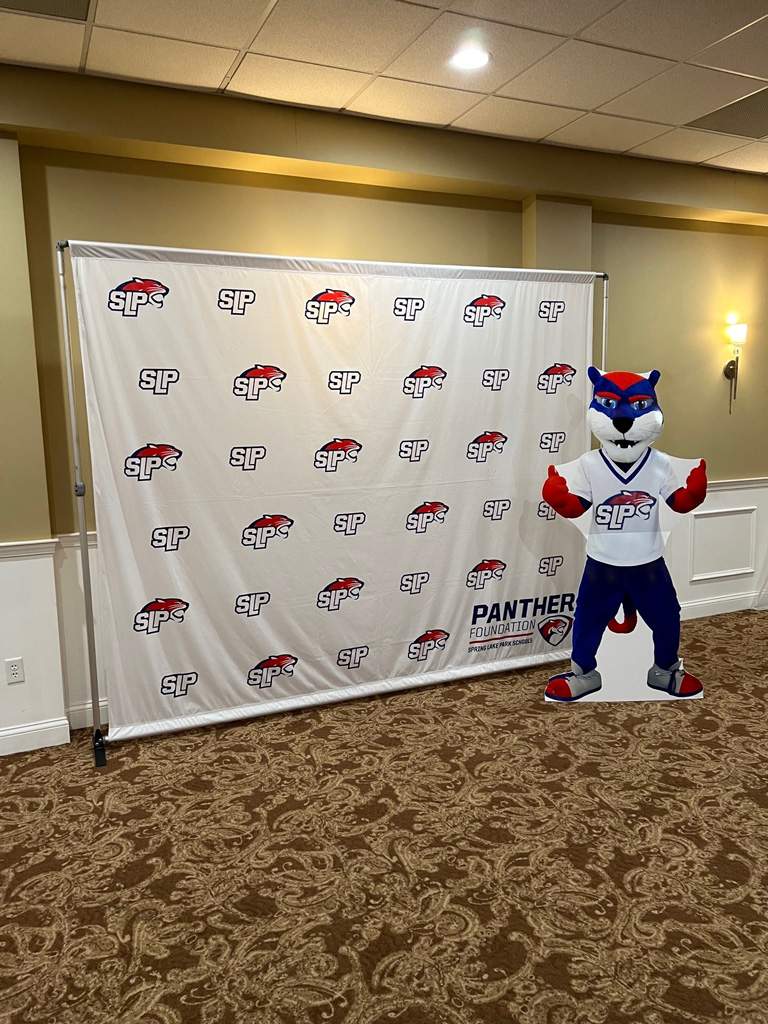 Branded backdrop with a wildcat mascot